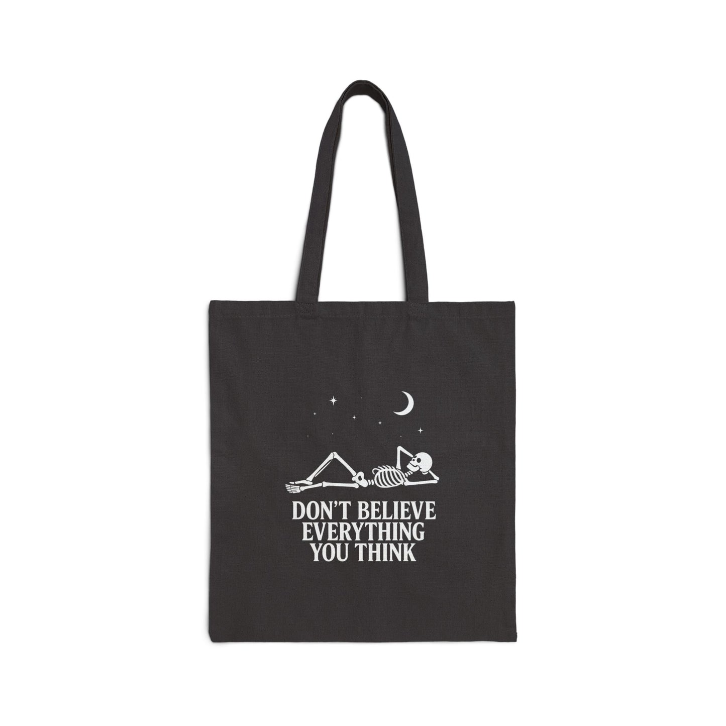 Minimalist skeleton silhouette tote bag with gothic quote “Don’t believe everything you think” under crescent moon and stars – SkeletonWear Apparel