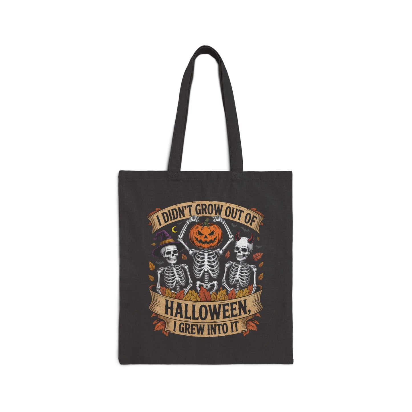Skeletons with pumpkin, witch hat, and devil horns under banner ‘I Didn’t Grow Out of Halloween, I Grew Into It’ – SkeletonWear Apparel Halloween tote bag design