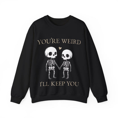 Two skeletons holding hands with a red heart, quirky “You’re Weird I’ll Keep You” text, gothic skeleton couple sweatshirt by SkeletonWear Apparel