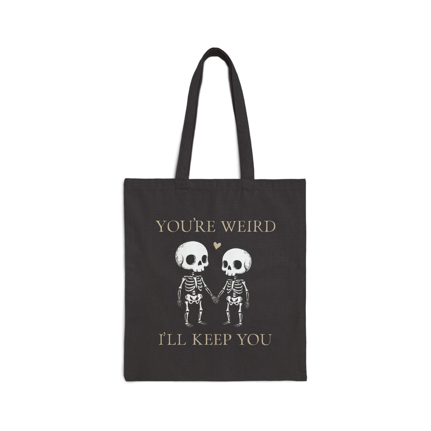 Two skeletons holding hands with a red heart, quirky “You’re Weird I’ll Keep You” text, gothic skeleton couple tote bag by SkeletonWear Apparel