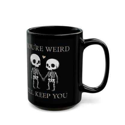 Two skeletons holding hands with a red heart, quirky “You’re Weird I’ll Keep You” text, gothic skeleton couple mug by SkeletonWear Apparel