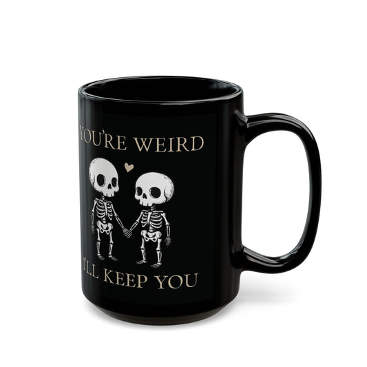 Two skeletons holding hands with a red heart, quirky “You’re Weird I’ll Keep You” text, gothic skeleton couple mug by SkeletonWear Apparel