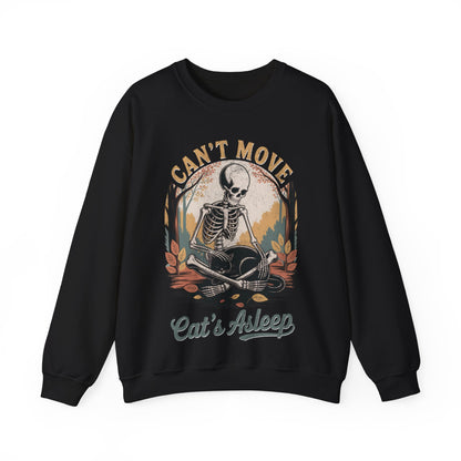 Relaxed skeleton cradling black cat with eyes closed – cozy gothic fall sweatshirt by SkeletonWear Apparel