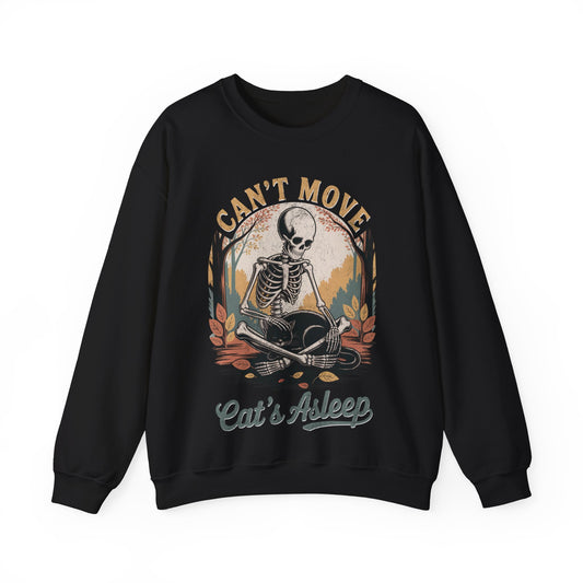 Relaxed skeleton cradling black cat with eyes closed – cozy gothic fall sweatshirt by SkeletonWear Apparel