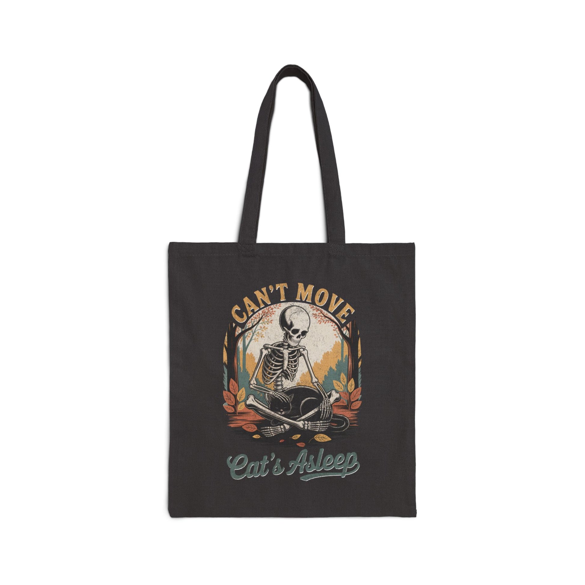 Relaxed skeleton cradling black cat with eyes closed – cozy gothic fall tote bag by SkeletonWear Apparel