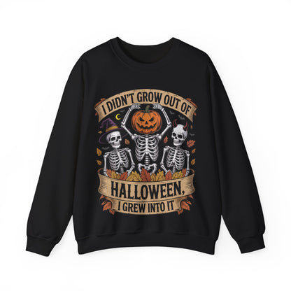 Skeletons with pumpkin, witch hat, and devil horns under banner ‘I Didn’t Grow Out of Halloween, I Grew Into It’ – SkeletonWear Apparel Halloween sweatshirt design