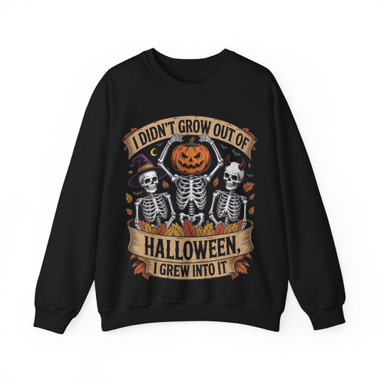 Skeletons with pumpkin, witch hat, and devil horns under banner ‘I Didn’t Grow Out of Halloween, I Grew Into It’ – SkeletonWear Apparel Halloween sweatshirt design