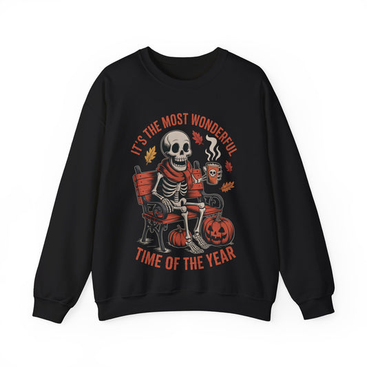 Skeleton in scarf sipping pumpkin spice latte on gothic bench with pumpkins and autumn leaves – cozy Halloween sweatshirt by SkeletonWear Apparel
